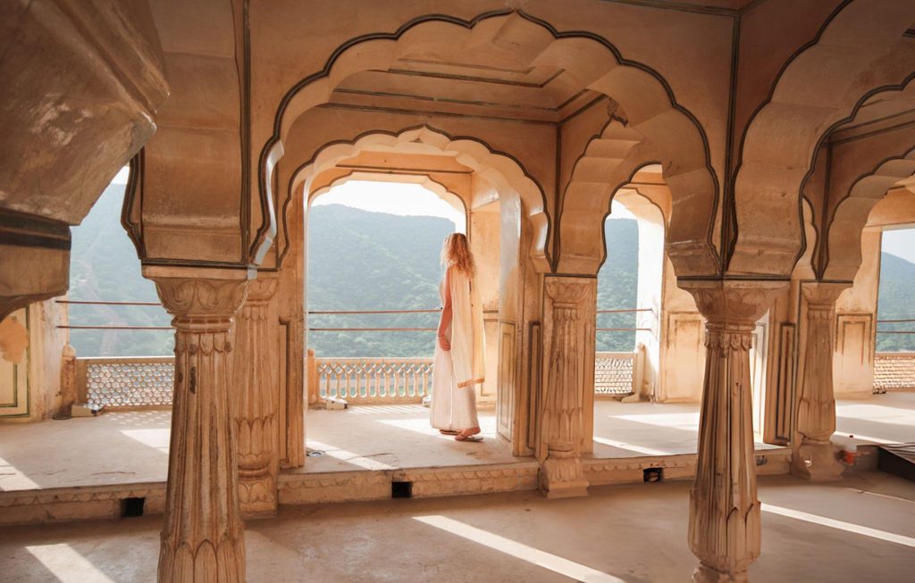 A traveler admiring the view from the Amer Fort in Jaipur, India, showcasing the architectural beauty of South Asian Gems.